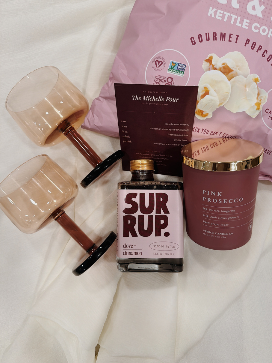Coupe glasses, gourmet popcorn, a candle and cinnamon syrup for a long-distance birthday gift